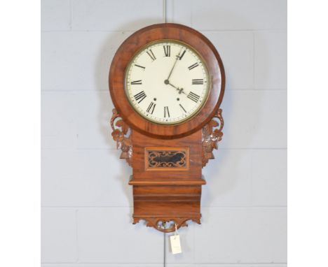 A late 19th/early 20th Century wall clock, the white enamel dial with roman hours, contained within a mahogany case with this