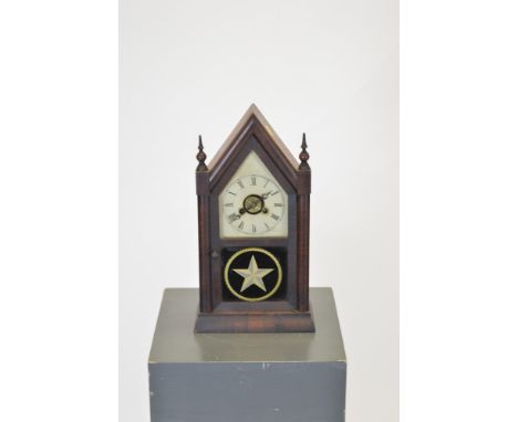 An early 20th Century mahogany mantel clock, with white painted dial, roman hours and arabic minutes striking a gong, contain