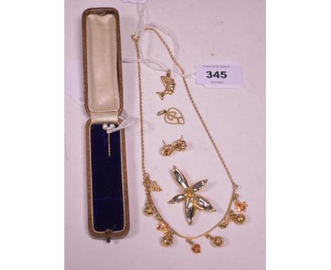 An Arabic yellow metal charm necklace; a pair of knot pattern earrings; two charms; a baroque pearl set tie pin; and a gold c