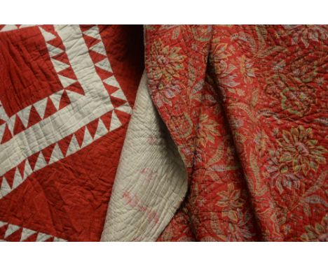 Two vintage Durham quilts, to include: red and white chevron pattern; and red floral pattern.