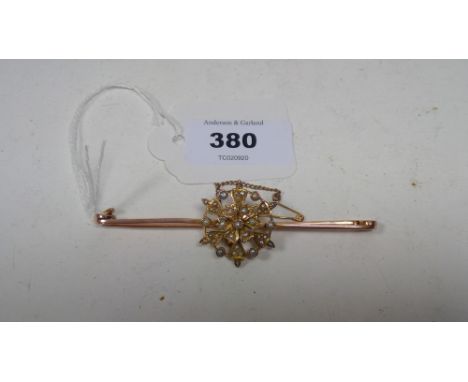 Edwardian seed pearl brooch, of snowflake form, on bar, stamped '9ct', 8.9g gross.