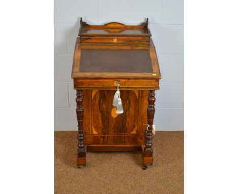 An early 20th Century rosewood Davenport, with raised superstructure above an inset writing surface enclosing an interior, ab
