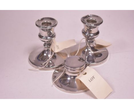 A pair of silver candlesticks, by John Round, Birmingham 1955; together with a silver capstan form inkwell, by William Neale,