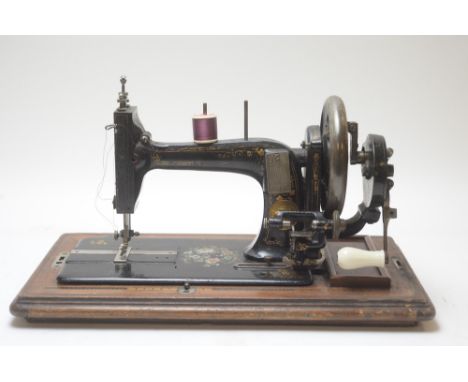 A vintage tabletop sewing machine, by Neumann, Dresden, South Shields, for Jans V Hoffman, in case; and an Edwardian inlaid m