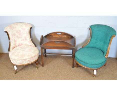 A pair of Victorian mahogany nursing chairs, with scroll-over and button backs, enclosed by a mahogany frame, raised on turne