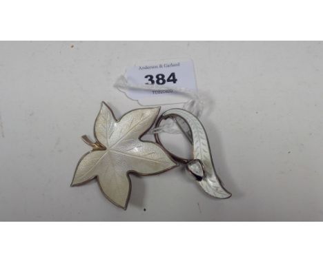A Norwegian silver and white enamel floral brooch, by Aksel Holmsen; and a Danish silver white enamel leaf pattern brooch, by