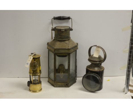 A vintage railway lamp; a vintage brass ship's quarter lamp; and a 'Protector' brass miner's lamp by Eccles.