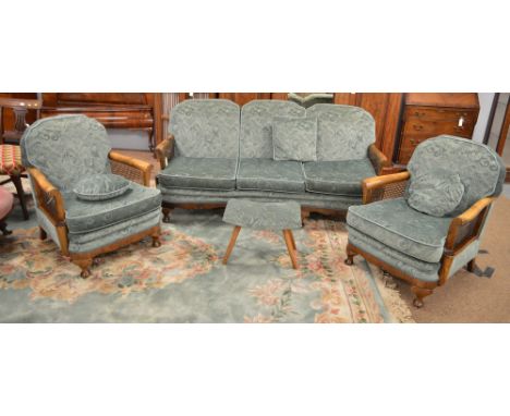 A walnut framed bergere three-piece suite, c 1940's, with scroll-over arms, comprising: a three-seater sofa and two armchairs