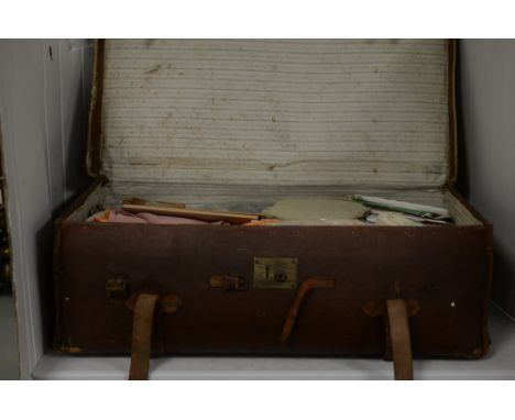 A 1940s travelling trunk, containing a collection of vintage fabrics and dress maker's templates, etc.