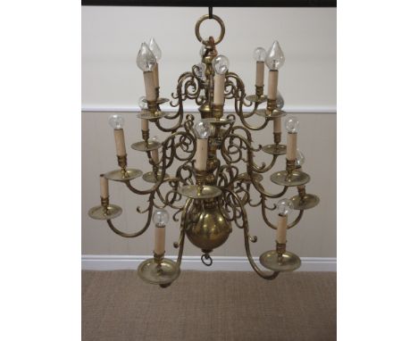 A large Dutch brass three tier, eighteen branch Chandelier of scroll design with bulbous base, 2ft 9in D