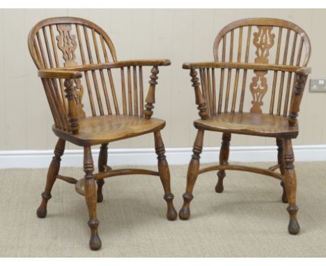 A pair of 19th Century Windsor Elbow Chairs having pierced splat and stick backs, solid seats on turned supports united by cr