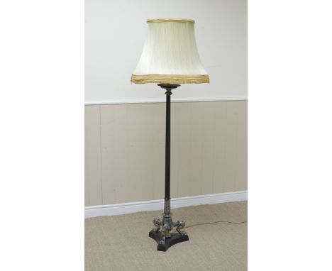 A metal Standard Lamp with fluted column on tripod base with paw feet