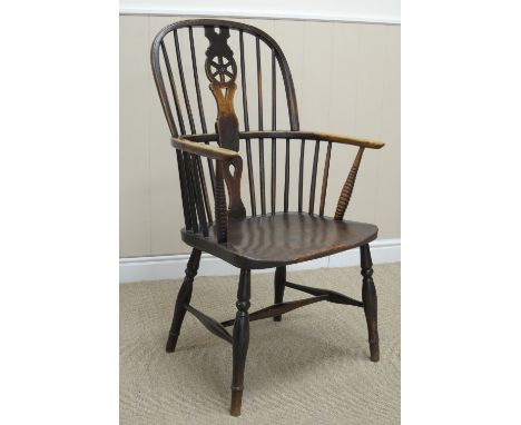 A 19th Century Windsor Elbow Chair in ash and elm, etc, with pierced wheel and stick back, solid seat on turned supports unit