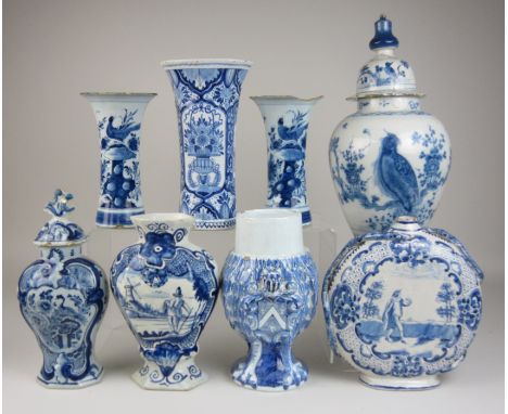 Eight Continental blue and white Delft Vases, including a rare vase and cover painted with parrots, a pair of trumpet vases p