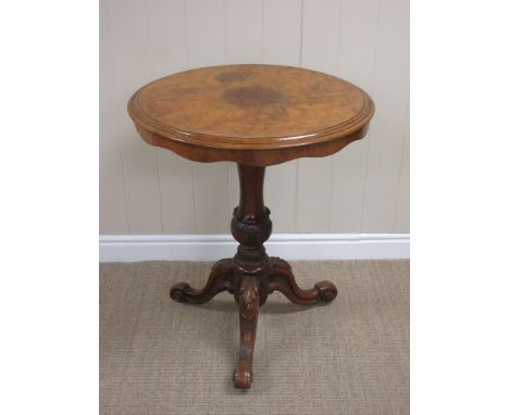 A 19th Century burr walnut Pillar Table the quartered moulded top above a shaped frieze on a turned moulded column above carv