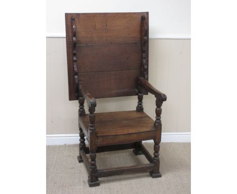 An antique oak Monk's Bench with hinged top/chair back, solid seat on turned and square supports, 2ft 4in, with some repairs