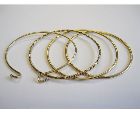 Three rigid 9ct gold Bangles and a Bangle set two brilliant-cut diamonds, approx 30gms