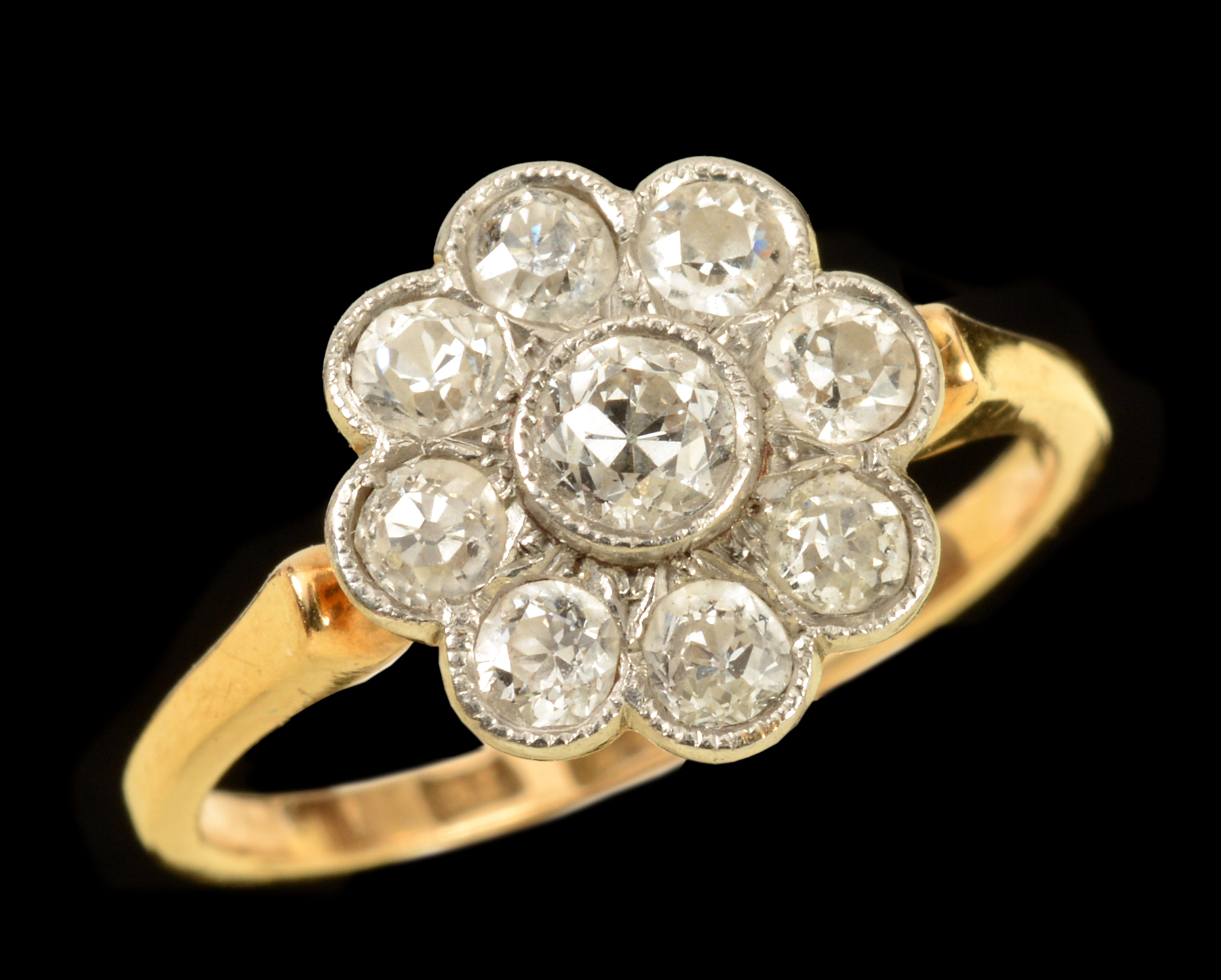 A Diamond Flower Cluster Ring millegrain-set nine old-cut stones