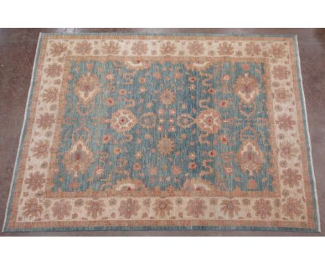 A bordered Persian Carpet with floral designs on a blue ground, 11ft 10in x 9ft