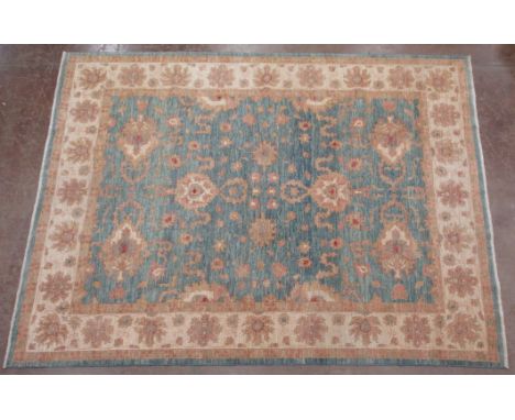 A bordered Persian Carpet with floral designs on a blue ground, 11ft 10in x 9ft