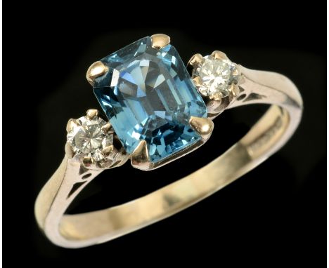 A Sapphire and Diamond three stone Ring claw-set step-cut sapphire between two brilliant-cut diamonds in 18ct white gold, rin