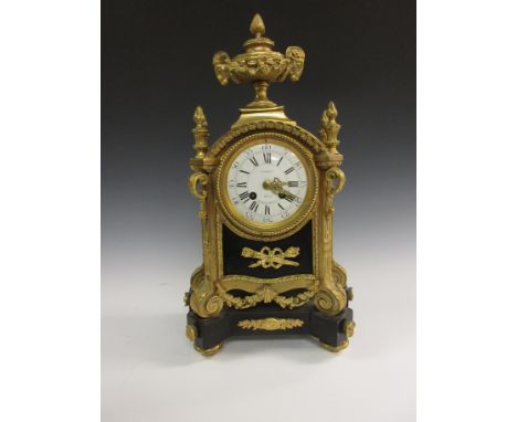 A 19th Century French Mantel Clock in ormolu and black marble case, with urn central finial having rams head and floral decor