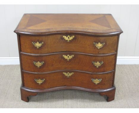 A 19th Century oak serpentine Chest of Drawers, the crossbanded moulded top above three long drawers raised on bracket feet, 