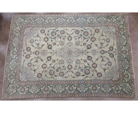 A bordered Kashan style Carpet with palmette design on pale blue ground, 14ft x 10ft