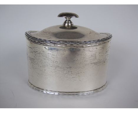 An Edward VII silver oval Tea Caddy with hinged cover and wavy rim, London 1906