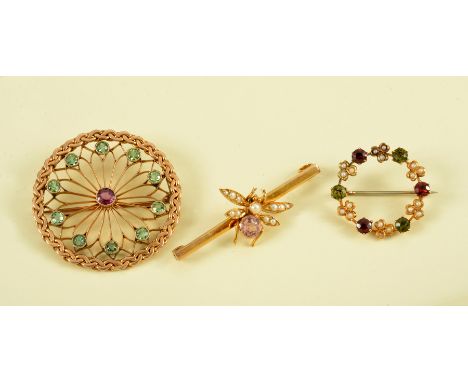An Amethyst and Peridot circular Brooch, a Seed Pearl, Garnet and Peridot Wreath Brooch and an Insect Brooch set seed pearls 