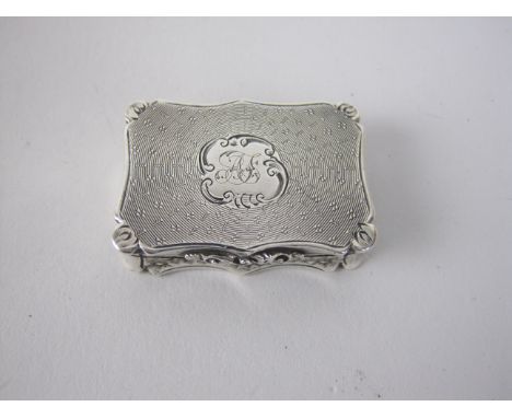 A Victorian silver shaped oblong Vinaigrette, engine turned and engraved initials, floral scroll pierced gilt grille, Birming