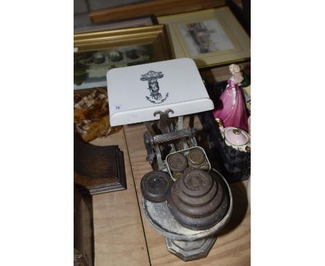 A set of cast iron scales With various weights, and ceramic scale plate. 