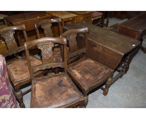 A set of four carved oak dining chairs and an oak drop leaf table on bobbin turned supports, 20th Century. (5) 