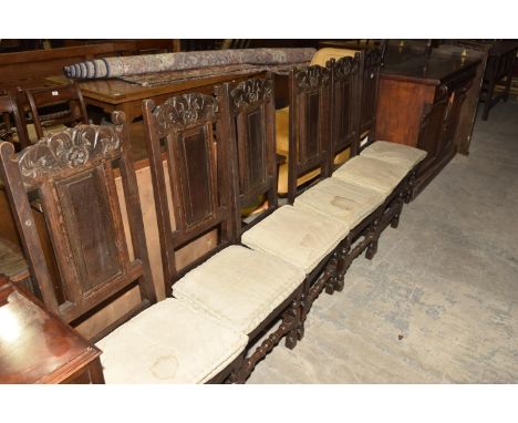 A set of six 18th Century oak panel back dining chairs on bobbin turned supports and cross stretchers. 