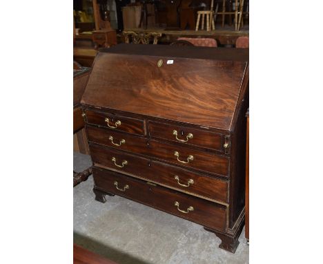 A George III mahogany bureau with two short over three long graduated drawers raised on bracket feet.Condition - drawers are 