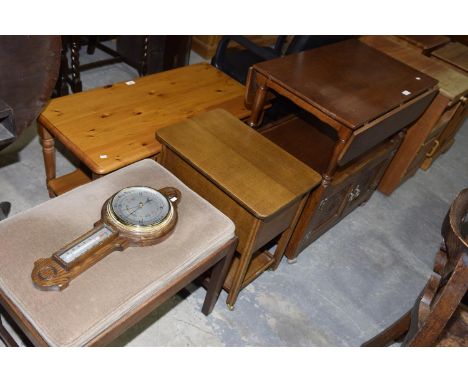 An oak Priory style tea trolley, an oak sewing table, an early 20th Century dressing stool and a Victorian style oak wall bar