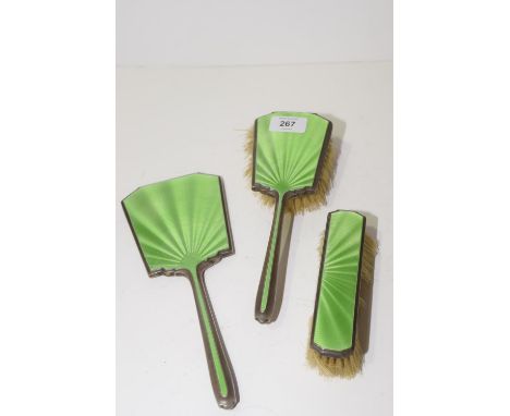 A silver and green enamel three piece dressing table set Hall marks rubbed, possibly Birmingham. (3) 