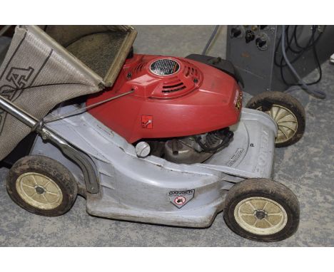 A Honda HR173 petrol rotary lawn mower. 