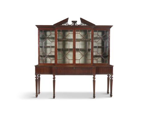 AN IRISH GEORGE III FOUR DOOR BREAKFRONT BOOKCASE,surmounted with pierced architectural pediment above astragal glazed doors,