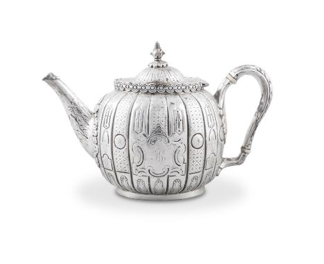 A VICTORIAN SILVER OVAL TEAPOT,Sheffield c.1860, mark of Reed and Barton, cast and chased in the Indo-Chinese taste, the body