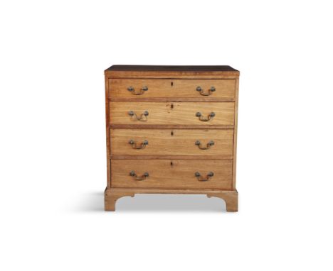 A GEORGE III COMPACT MAHOGANY CHEST OF DRAWERS,fitted with four long graduated drawers, with brass handles and outset bracket