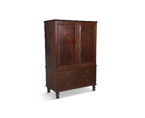 A GEORGE III COMPACT GENTLEMAN'S WARDROBE with twin fielded panel doors, shelved interior and chest base on turned bun feet. 