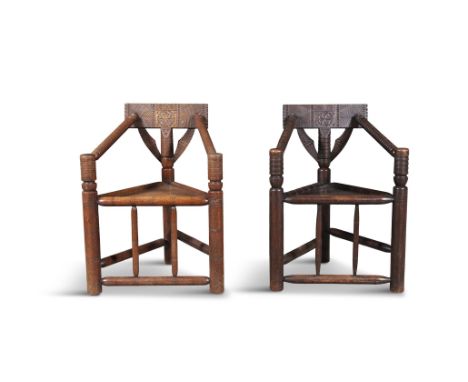A PAIR OF VICTORIAN OAK 'TURNERS' CHAIRS the crest rails with carved decoration, spiral turned arms, solid triform seats, on 