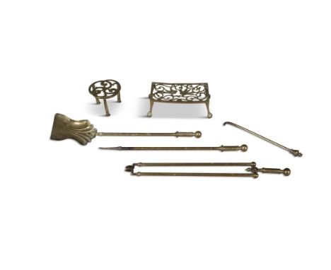 A COLLECTION OF BRASS FIRE TOOLS, comprising two pokers, coal shovel, tong and one large and one small trivet, tongs 63cm lon