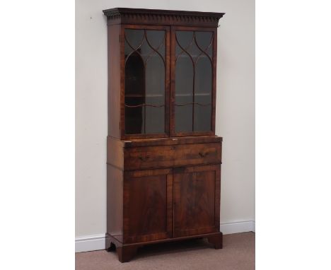 Regency mahogany secretaire bookcase, enclosed by two serpentine astragal glazed doors, fall front drawer fascia enclosing wr