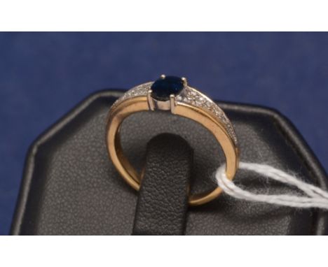 Sapphire and diamond ring, the central sapphire flanked by diamond shoulders, on yellow metal shank.