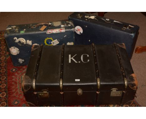 A black travel trunk marked K.C.; together with three vintage suit cases.