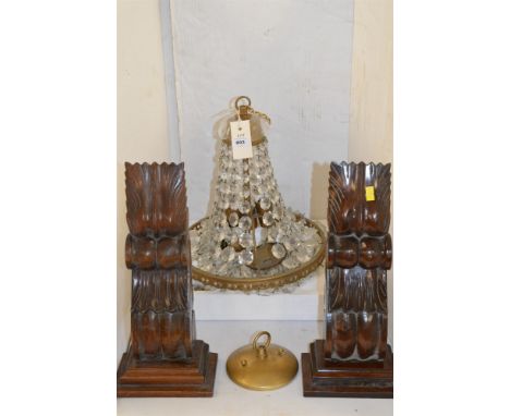 A brass and glass chandelier ceiling light; together with a pair of carved scrolling corbels.