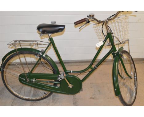 A vintage style Raleigh lady's bicycle with Brooks seat, Sturmey Archer gears, and a kick stand.