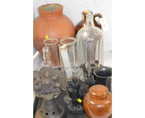 Two ceramic incense burners of peacock design; a glass bottle with hand design; various measuring cylinders; a large glass bo